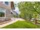 Well-maintained backyard with artificial turf, trees, and a wooden fence at 15705 Red Deer Dr, Morrison, CO 80465