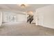 This spacious, well-lit basement has gray carpet and stairs leading to the upper floor at 15705 Red Deer Dr, Morrison, CO 80465