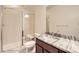 A clean bathroom with granite counters, shower, toilet, and a large mirror at 15705 Red Deer Dr, Morrison, CO 80465
