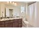 Bathroom featuring a marble counter, dark wood cabinets, and a shower with curtain at 15705 Red Deer Dr, Morrison, CO 80465