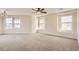 Spacious bedroom with neutral carpet, multiple windows, and modern ceiling fan at 15705 Red Deer Dr, Morrison, CO 80465