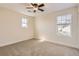 Bedroom with neutral carpet, ceiling fan, and two windows with blinds at 15705 Red Deer Dr, Morrison, CO 80465