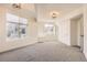 This bedroom is well-lit with gray carpet, two windows, recessed lights, and a walk-in closet at 15705 Red Deer Dr, Morrison, CO 80465