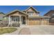 Charming two-story home with stone accents, covered porch, three-car garage, and professionally landscaped yard at 15705 Red Deer Dr, Morrison, CO 80465