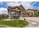 Attractive two-story home with a well-manicured lawn and a three-car garage at 15705 Red Deer Dr, Morrison, CO 80465