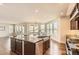 Gourmet kitchen featuring a large island, stainless steel appliances, custom cabinetry, and modern lighting at 15705 Red Deer Dr, Morrison, CO 80465
