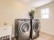 Laundry room featuring a utility sink, new washer and dryer, and natural light at 15705 Red Deer Dr, Morrison, CO 80465