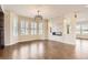Open-concept living room boasts a fireplace, hardwood floors, large windows, plantation shutters, and stylish light fixture at 15705 Red Deer Dr, Morrison, CO 80465
