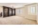 Room with large wooden bookshelf, neutral carpet, plantation shutters and modern lighting at 15705 Red Deer Dr, Morrison, CO 80465
