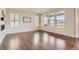 Bright living room with hardwood floors, plantation shutters, a modern fireplace, and large windows at 15705 Red Deer Dr, Morrison, CO 80465