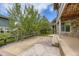 Spacious patio area with trees and a wooden fence surrounding the backyard at 15705 Red Deer Dr, Morrison, CO 80465