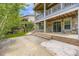 Back patio with stone accents and steps leading up to a second-story balcony at 15705 Red Deer Dr, Morrison, CO 80465