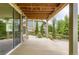 Back patio with stone accents, large sliding glass doors, and views of the backyard at 15705 Red Deer Dr, Morrison, CO 80465