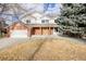 Two-story brick home with a white upper level, attached garage, and landscaping at 1861 Red Fox Pl, Highlands Ranch, CO 80126