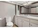 This bathroom offers a sleek, modern sink and toilet with plenty of storage space below at 6330 Montview Blvd, Denver, CO 80207