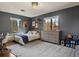 This bedroom features a large rug, light colored wood bed frame, gray walls, and abundant natural light at 6330 Montview Blvd, Denver, CO 80207