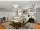 Comfortable bedroom with white decor, a plush bed, stylish rug, and plenty of natural light at 6330 Montview Blvd, Denver, CO 80207