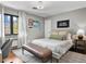 Bright bedroom features a platform bed, desk and a window seat for a comfortable and inviting space at 6330 Montview Blvd, Denver, CO 80207