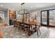 Open dining room features stylish lighting, large table and an artistic display of glassware for an elegant modern design at 6330 Montview Blvd, Denver, CO 80207