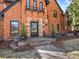 Brick Tudor style home with a stone entry, detailed trim, and a well-manicured lawn at 6330 Montview Blvd, Denver, CO 80207