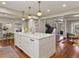 Spacious kitchen with a large island, ample storage, and hardwood floors, ideal for entertaining at 6330 Montview Blvd, Denver, CO 80207