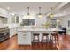Bright kitchen features a large island, pendant lighting, modern appliances, and a cozy eat-in area at 6330 Montview Blvd, Denver, CO 80207