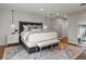 Bright main bedroom with a large bed, shiplap wall, pendant lighting and a neutral-colored rug at 6330 Montview Blvd, Denver, CO 80207