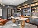 Modern office with custom built-ins, a sleek desk, and ample natural light from French doors at 6330 Montview Blvd, Denver, CO 80207