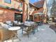 An inviting backyard patio with a fire pit, comfortable seating, and an outdoor dining area at 6330 Montview Blvd, Denver, CO 80207