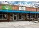 Quaint Ems Ice Cream storefront with a blue awning and outdoor picnic tables for customers to enjoy at 6330 Montview Blvd, Denver, CO 80207