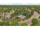 Aerial view of a community featuring a pool, tennis court, clubhouse and tree-lined streets at 6936 S Knolls Way, Centennial, CO 80122
