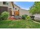 Cozy back yard featuring lush lawn, garden beds, wood fencing and an outdoor patio area at 6936 S Knolls Way, Centennial, CO 80122