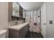 Renovated bathroom showcases double sink vanity, updated fixtures, and tiled shower at 6936 S Knolls Way, Centennial, CO 80122