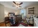 Inviting bedroom with wood floors, ceiling fan, accent chair, and cozy decor at 6936 S Knolls Way, Centennial, CO 80122