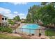 Inviting community pool area featuring lounge chairs, tables and lush greenery at 6936 S Knolls Way, Centennial, CO 80122