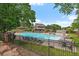 Inviting community pool area featuring lounge chairs, tables and lush greenery at 6936 S Knolls Way, Centennial, CO 80122