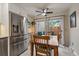 Bright dining area features stainless steel refrigerator, outdoor access, and wooden table at 6936 S Knolls Way, Centennial, CO 80122