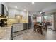 Open kitchen with stainless steel appliances, white cabinets, a dining area, and sliding glass doors to the outdoor deck at 6936 S Knolls Way, Centennial, CO 80122