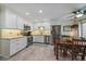 Bright kitchen with stainless steel appliances, ample counter space, white cabinets, and an adjacent dining area at 6936 S Knolls Way, Centennial, CO 80122