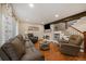 Inviting living room with hardwood floors, a cozy fireplace, comfortable furniture, and plenty of natural light at 6936 S Knolls Way, Centennial, CO 80122