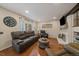 Comfortable living room with hardwood floors, a fireplace, recessed lighting, and a decorative shelving unit at 6936 S Knolls Way, Centennial, CO 80122