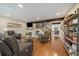 Spacious living room features hardwood floors, a fireplace, modern furniture, and open access to the kitchen at 6936 S Knolls Way, Centennial, CO 80122