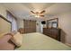Comfortable main bedroom boasts wood floors, ceiling fan, and rustic sliding barn door at 6936 S Knolls Way, Centennial, CO 80122
