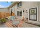 Inviting outdoor patio with wicker furniture, a colorful rug, and tasteful decor, perfect for relaxation and entertaining at 6936 S Knolls Way, Centennial, CO 80122