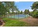 Well-maintained tennis court with surrounding fence and greenery in a community at 6936 S Knolls Way, Centennial, CO 80122