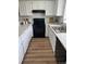 Bright kitchen features white cabinets, new flooring, and modern appliances at 1100 S Waco St # G, Aurora, CO 80017