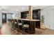 Basement bar with stone accent wall and seating for five at 7475 W Kentucky Ave, Lakewood, CO 80226