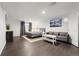 Finished basement bedroom with a queen bed and gray sofa at 7475 W Kentucky Ave, Lakewood, CO 80226