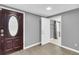 Basement entrance with dark wood door and gray walls at 7475 W Kentucky Ave, Lakewood, CO 80226