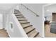Basement stairs with light gray walls and wood-look steps at 7475 W Kentucky Ave, Lakewood, CO 80226